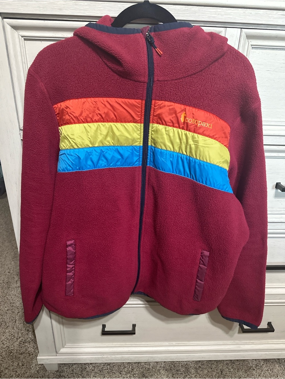 cotopaxi Maroon Hooded Fleece Jacket with Orange-Yellow-Blue Stripes